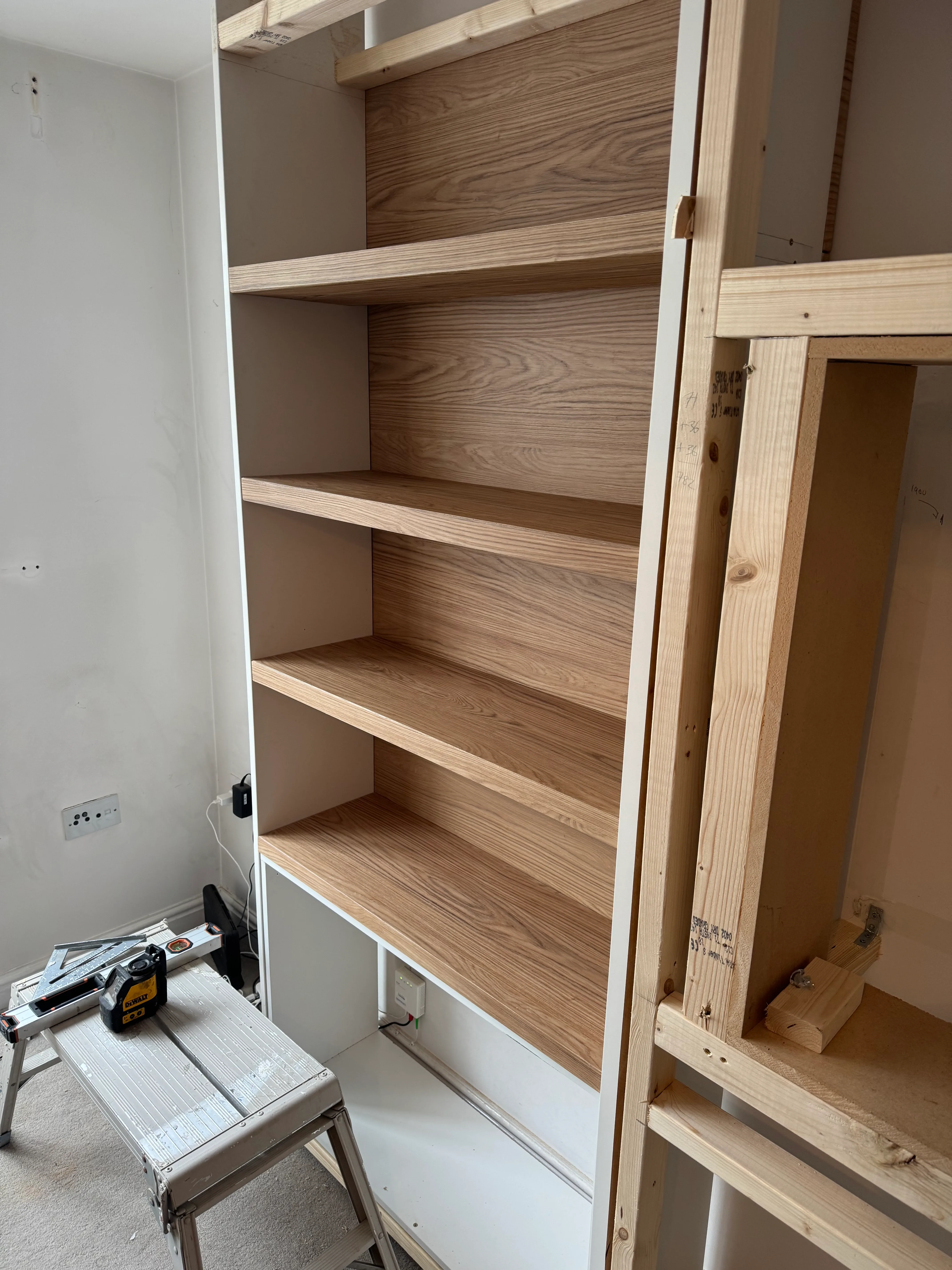 Oak shelves being fitted into the alcove during the Canton build